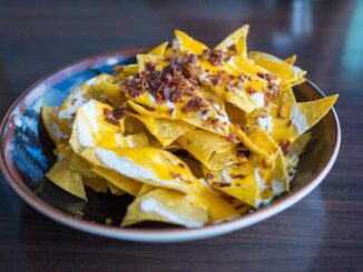 Nachos are a Mexican food consisting of fried tortilla chips or totopos covered with melted cheese or cheese sauce, as well as a variety of other toppings (PHOTO CREDIT: Larry White/pixabay)